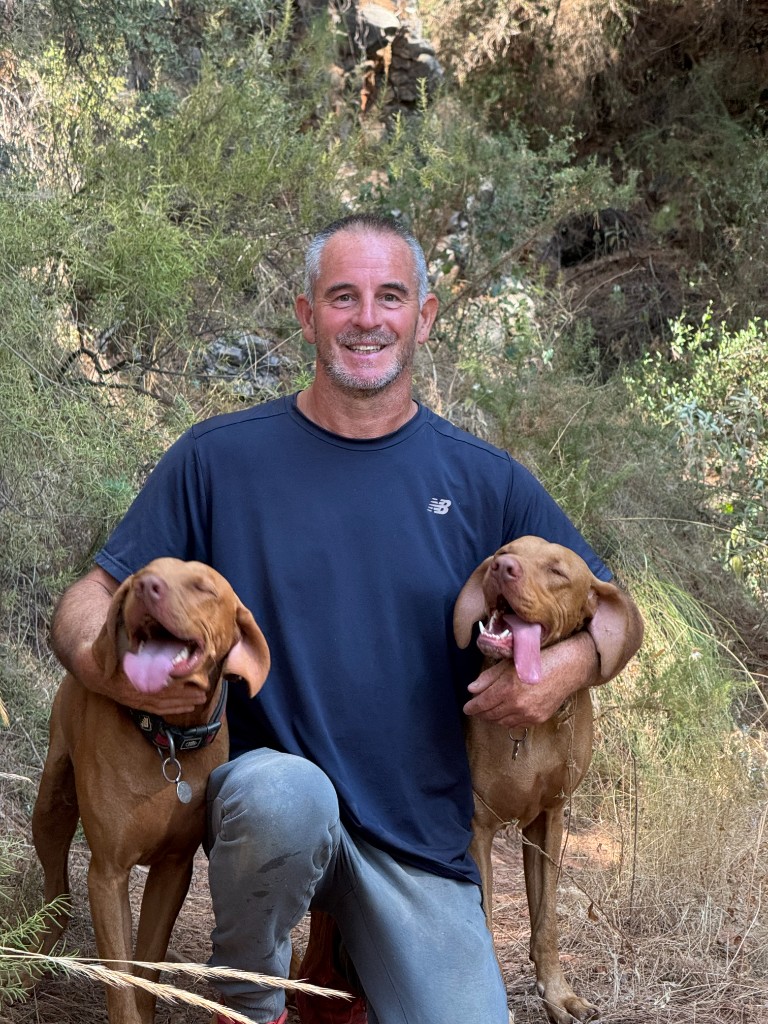 Jon Brown with two happy dogs he recently transported